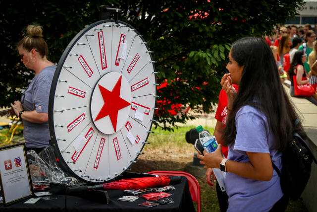A student spins a prize wheel at Buck-i-Frenzy.
