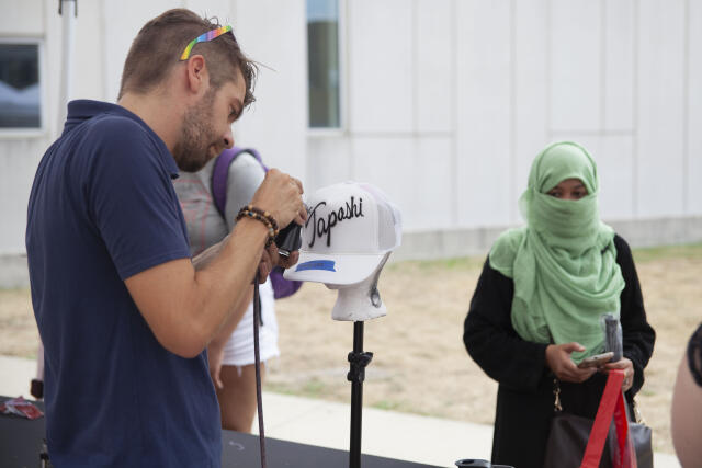 A student customizes a hat at Buck-i-Frenzy.